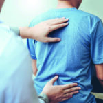 Doctor consulting with patient Back problems Physical therapy concept