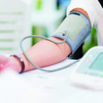 Doctor checking patient arterial blood pressure in hospital. Health care Concept