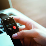 Close up of hand touching smartwatch with health app on the screen, gadget for fitness active lifestyle.